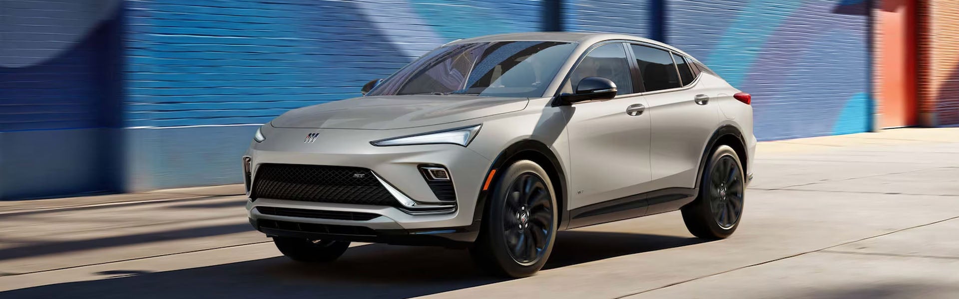 2026 Buick Envista silver crossover driving on a city street