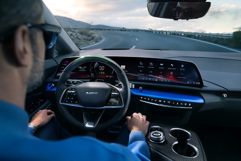 Front View of the 2026 OPTIQ-V Driving Through the Dusk Utilizing its Headlights | Schwan Buick GMC in Mandan ND