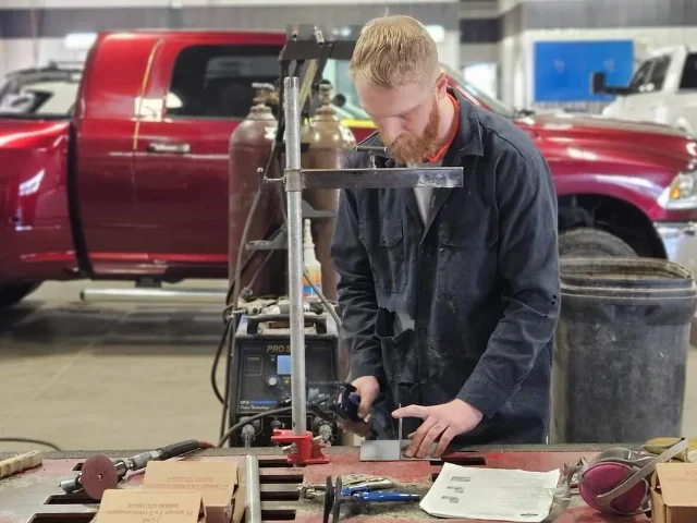 Person using a saw on a car 